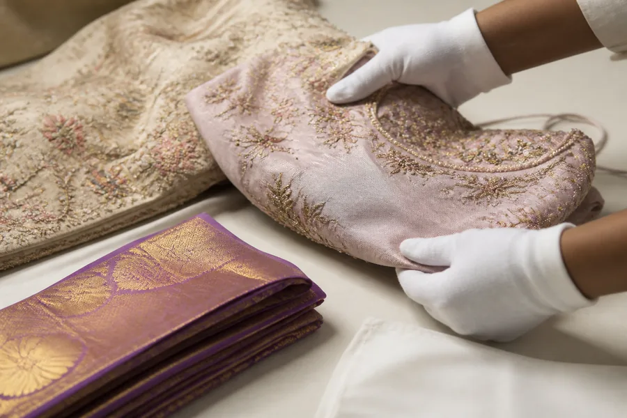 Careful inspection of embroidered Indian premium garments